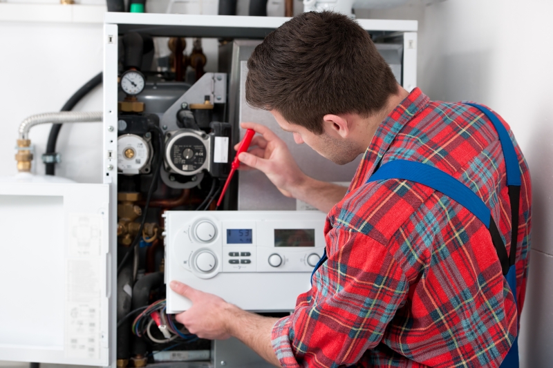 Gas Safe engineer working on a boiler in Brentford