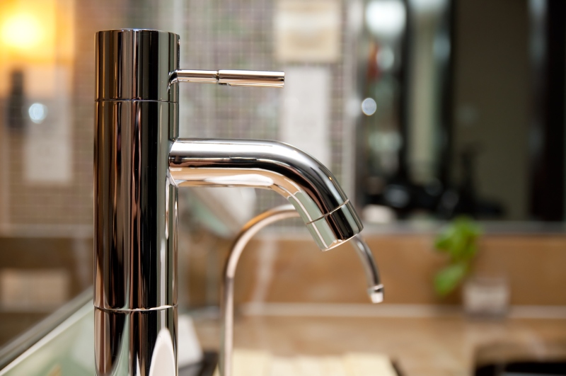 Leaking tap being repaired in Brentford